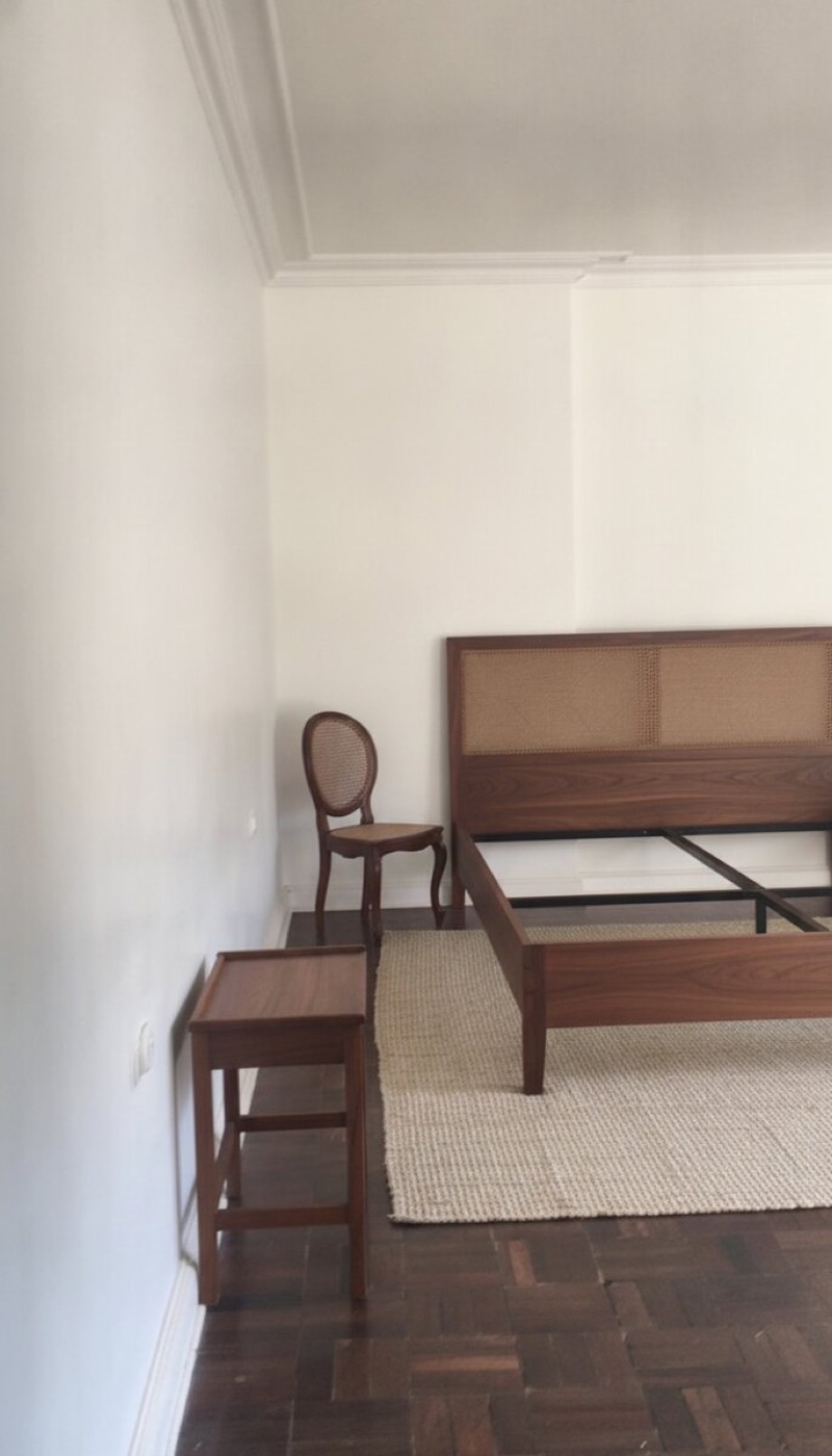 Same room with the chair refinished and re-caned, rug and side table added