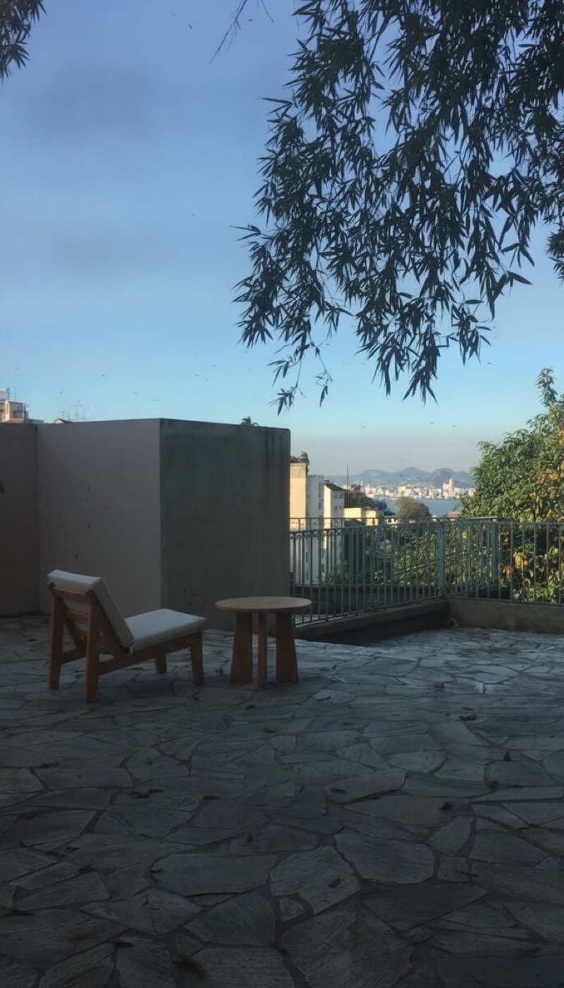 Same terrace with a simple outdoor chair and side table added