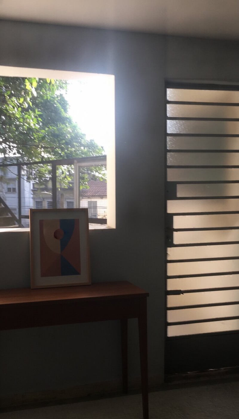 Same corridor with a console table and framed art added