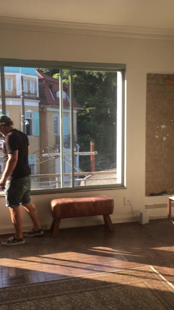 Campaign-style stool bench near the window