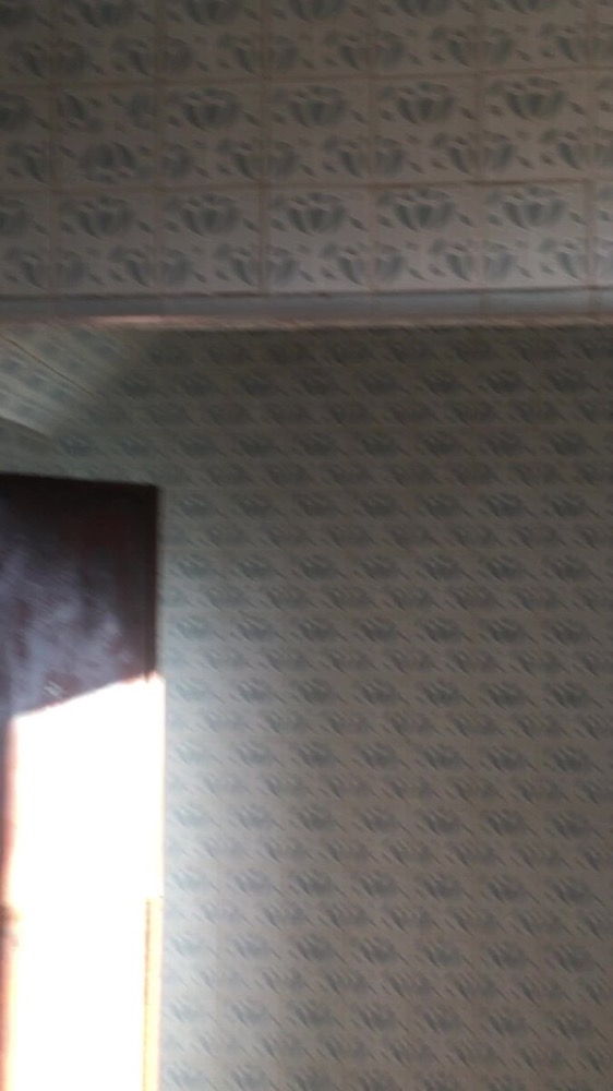 Close-up of the original patterned wallpaper