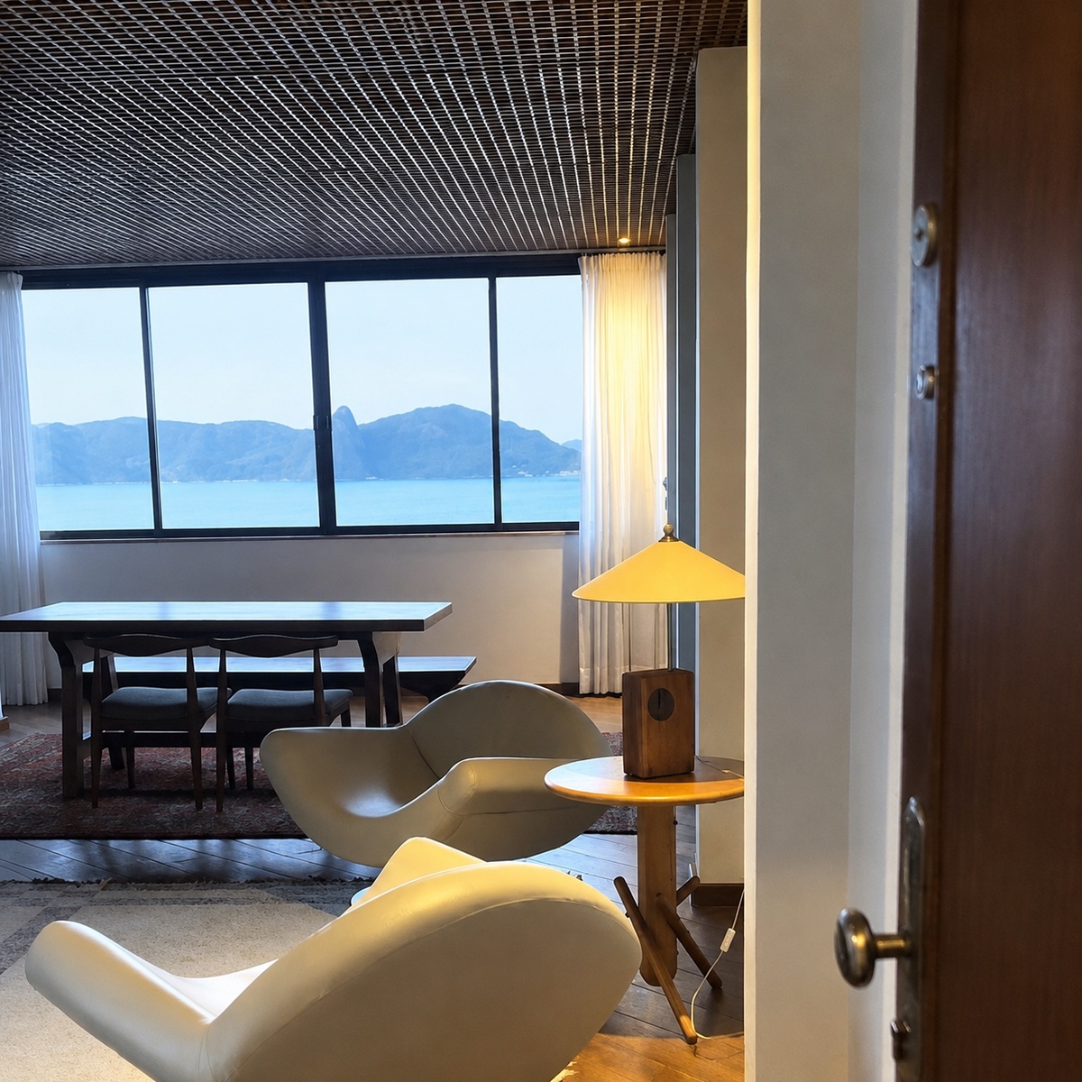 Penthouse living area with dining table and bay view