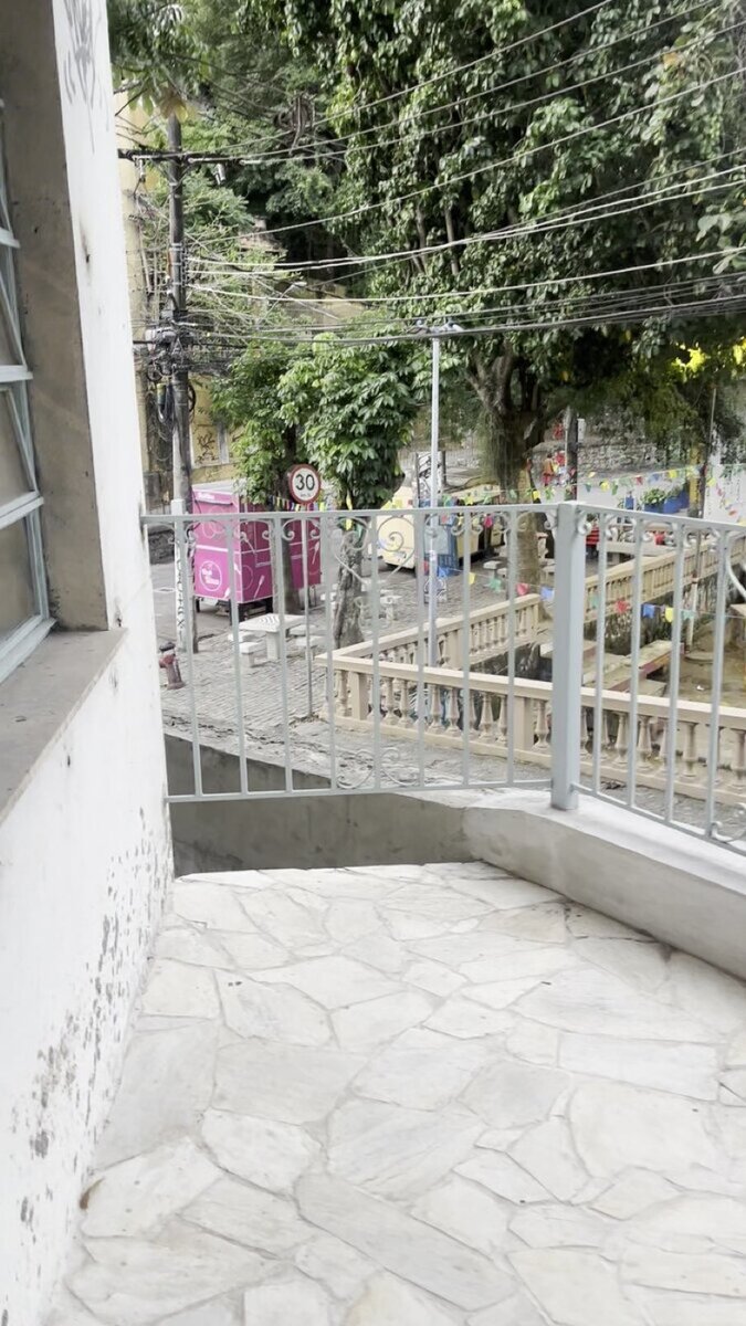 Balcony with colorful street bunting and view over Santa Teresa