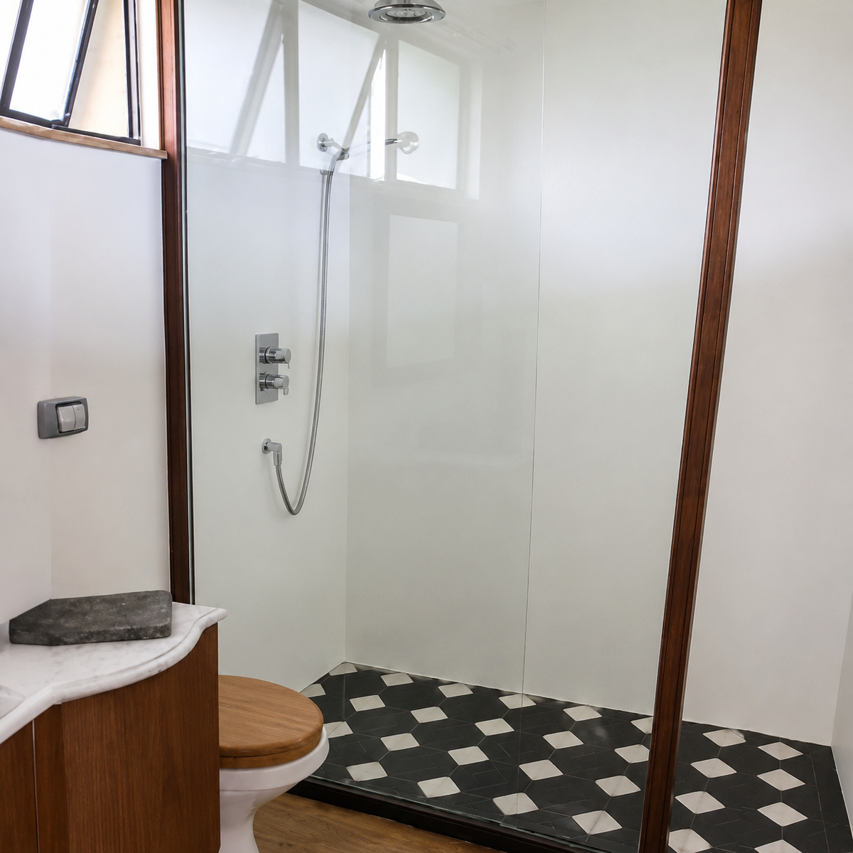Full bathroom with glass-enclosed shower and patterned tile floor