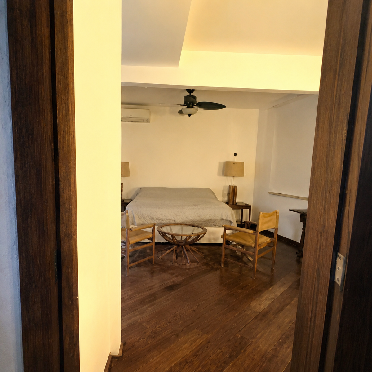 Second bedroom with wood-frame bed and ceiling fan
