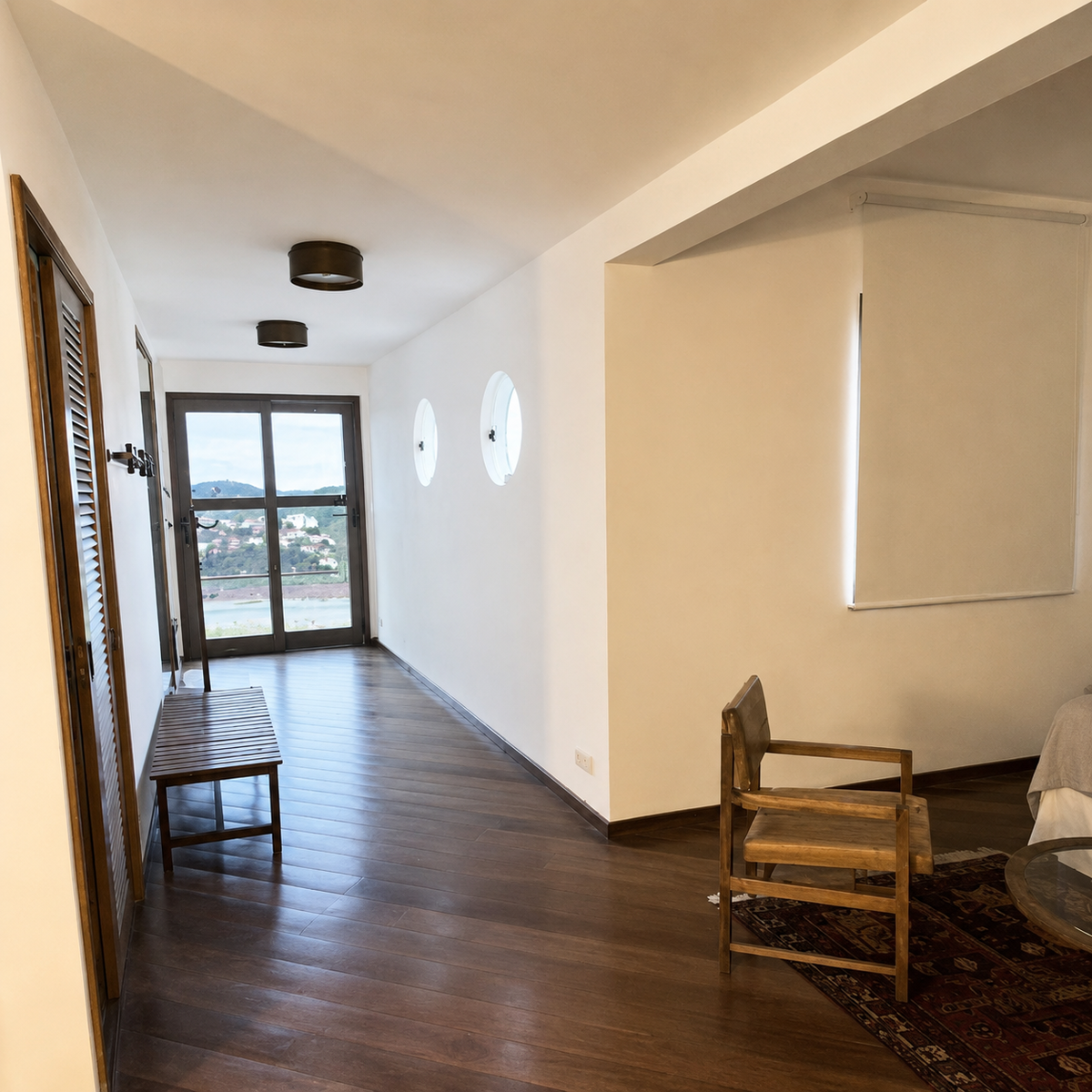 Hallway with round porthole windows leading to the terrace