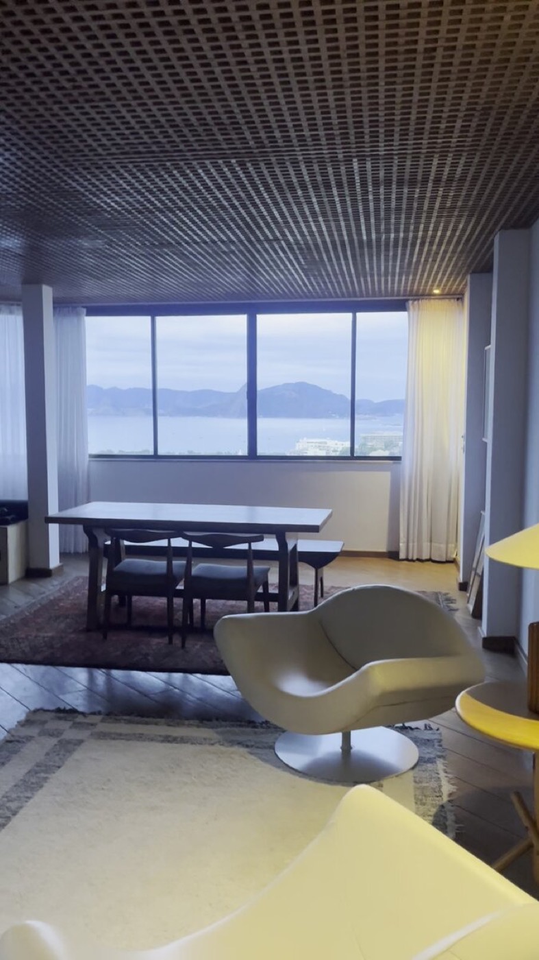 Sculptural lounge chair, dining table and mustard armchair in the penthouse