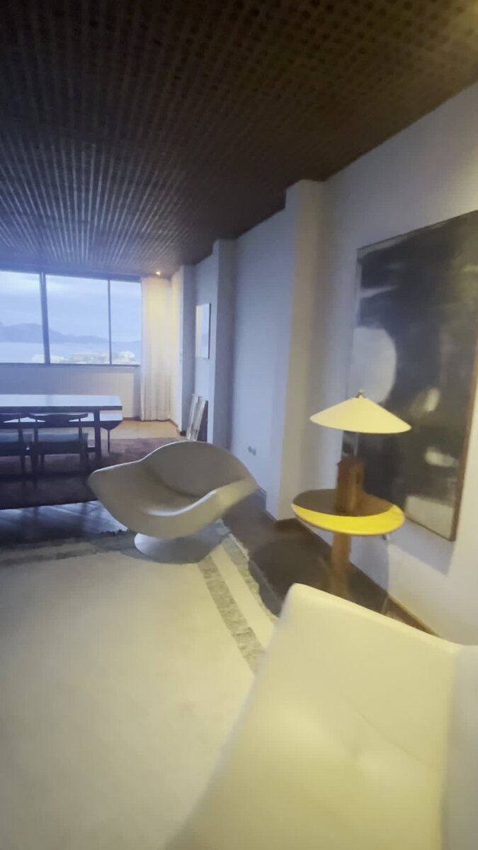 Sculptural lounge chair and dining table, alternate angle, with bay view
