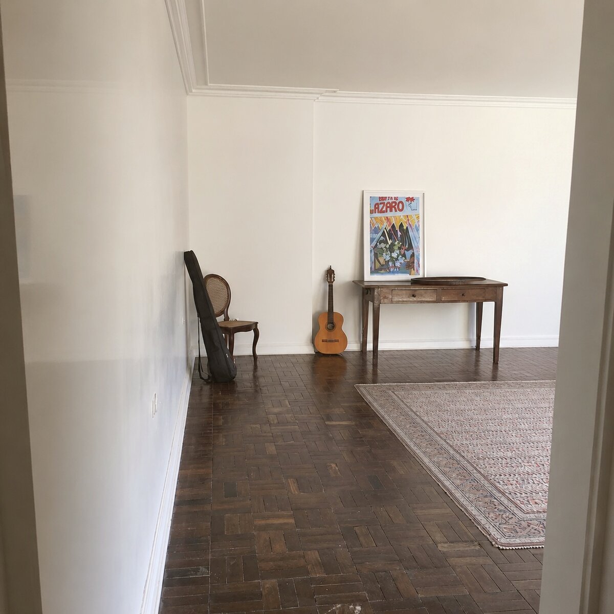 Original cane chair, guitar, and antique console table left mid-move