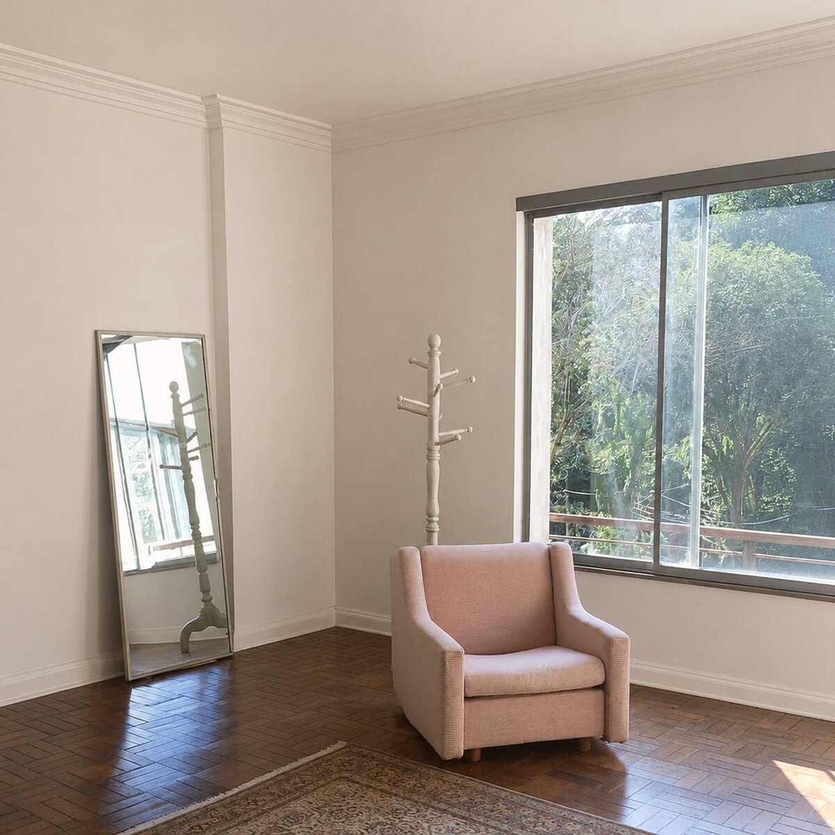 Empty room with pink armchair, floor mirror, and coat rack — no bed