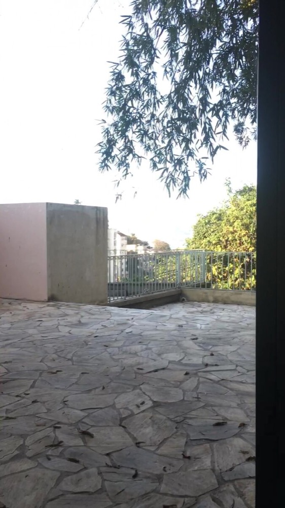 Terrace corner with bamboo, pink wall and railing