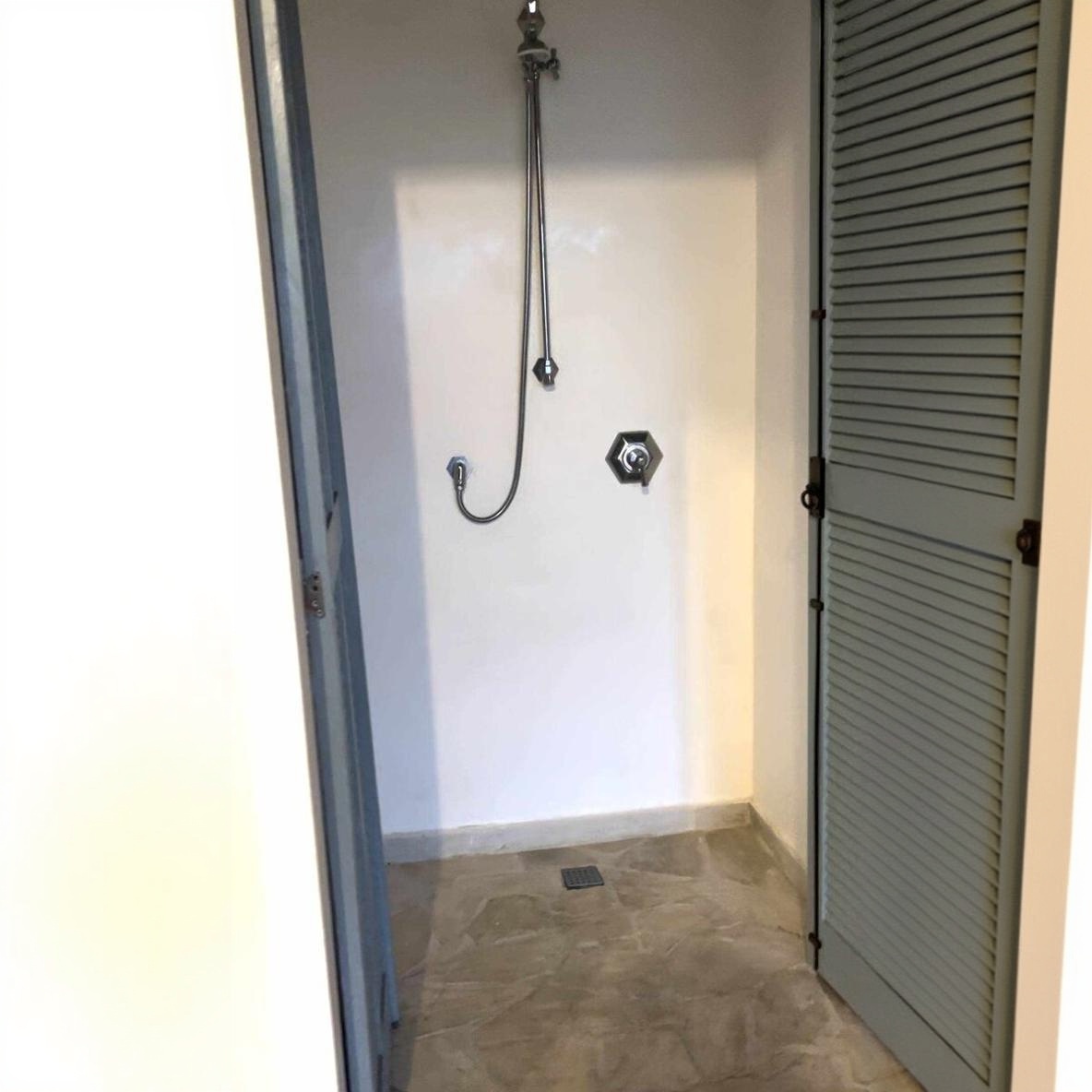 Shower behind a louvered door
