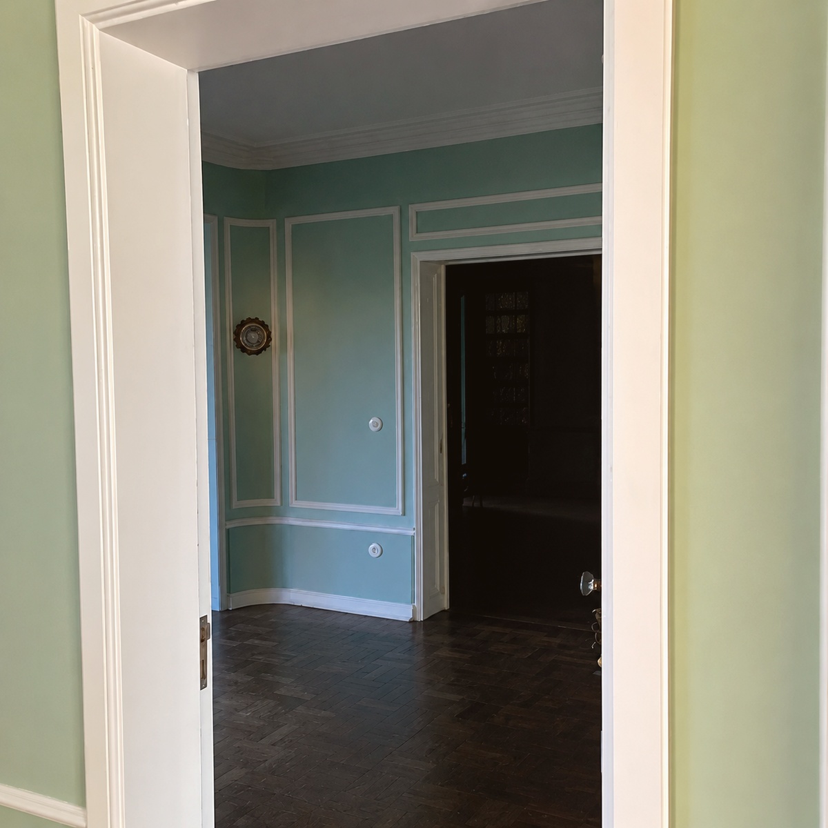 Room painted mint green with wainscoted walls